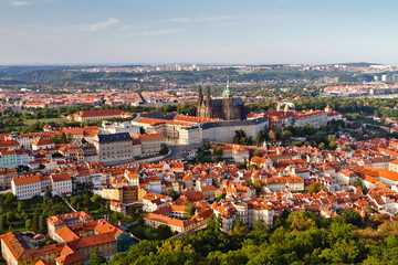 Naklejka na ściany i meble Aerial view of the city. St. Vitus Cathedral over old town red roofs. Prague, Czech Republic