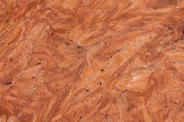 Abstract of rippled orange-red sand 
