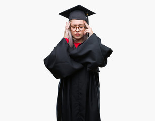 Young blonde woman wearing graduate uniform over isolated background with hand on head for pain in head because stress. Suffering migraine.