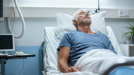 In the Hospital, Senior Patient Lying in Bed, Sleeping. Modern Hospital Geriatrics Ward.