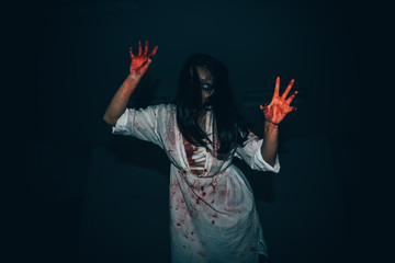 Portrait of asian woman make up ghost face with blood,Horror scene,Scary background,Halloween poster,Thailand people