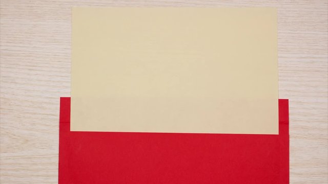 A red envelope opens and a blank sheet of paper appears. Stop motion animation