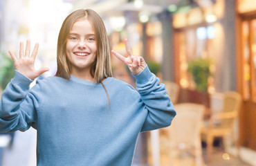 Young beautiful girl wearing winter sweater over isolated background showing and pointing up with...
