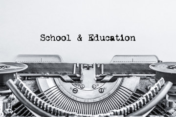 School and education text typed on a vintage typewriter, black ink on an old paper