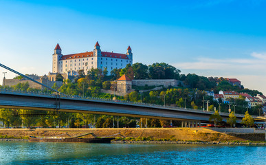Bratislava castle over Danube river with new bridge in foreground.