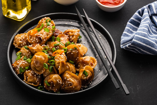 Fried dumplings with soy sauce with pepper and green onions. Asian cuisine