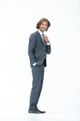 businessman straightening his tie isolated on a white background