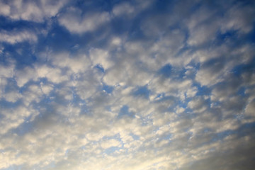 Small white clouds on blue sky