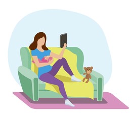 A young mother on the couch breastfeed a newborn baby