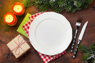 Christmas table setting with candles and xmas gift