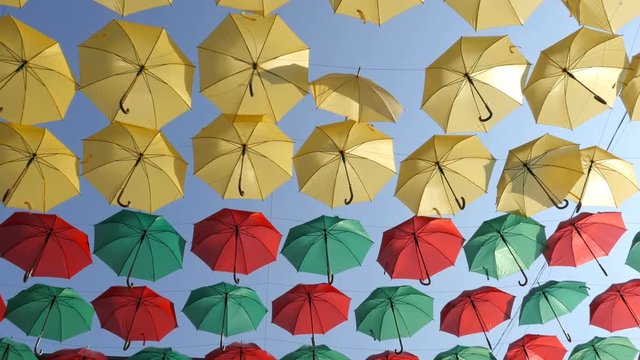 Colorful umbrellas on the wind. Umbrellas on the street
