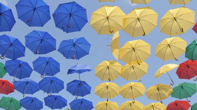 Decorative umbrellas on the street. Colorful umbrellas place. Slider view
