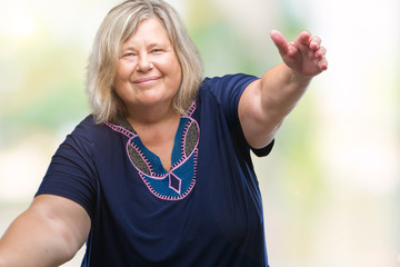 Senior plus size caucasian woman over isolated background looking at the camera smiling with open arms for hug. Cheerful expression embracing happiness.