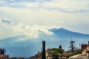 Etna volcano with clouds surrounding the mountain top