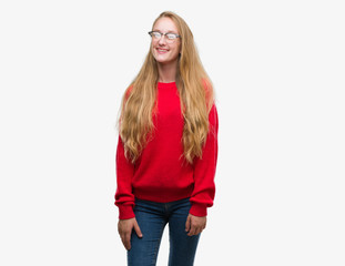 Blonde teenager woman wearing red sweater with a happy and cool smile on face. Lucky person.