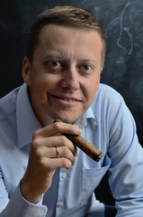 Man in blue shirt smoking cigar