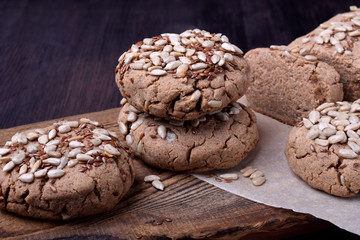 Wholegrain gluten-free buckwheat bread with sunflower and flax seeds on a wooden board