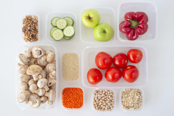 Storage of vegetarian food in plastic containers. Healthy eating. Order in the kitchen and in the fridge. Top view, flat lay