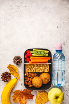 Healthy meal prep containers with cereal bar, fruits, vegetables and snacks. Takeaway food on white background, top view.