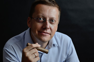 Man in blue shirt with cigar