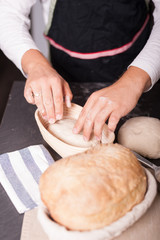Placing a sourdough in a bowl to make it rise. 