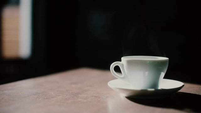 Color footage of some steam coming out of a coffee cup.
