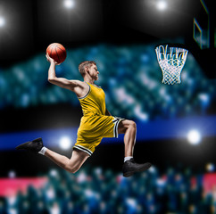 basketball player making slam dunk on basketball arena
