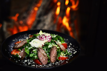 Salad with fresh vegetables and meat topped with cheese for healthy dieting. Dieting day. Healthy eating habits promote life