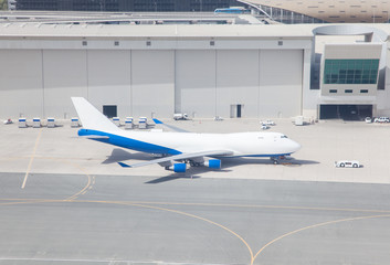 Airplane and service vehicles in the airport terminal