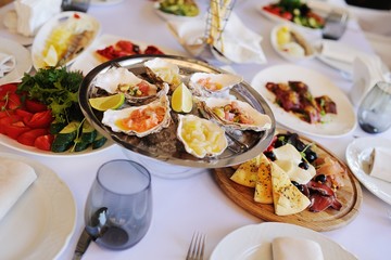 Seafood. Mollusc shellfish. Baked mussels with cheese, cilantro and lemon in oyster shells.
