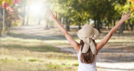 girl with arms aloft celebrating autumn