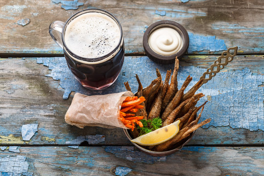 Deep fried fishes with carrots sticks, beer appetizer, copy space