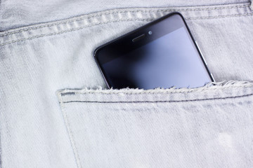 Closeup to jeans pocket with smartphone