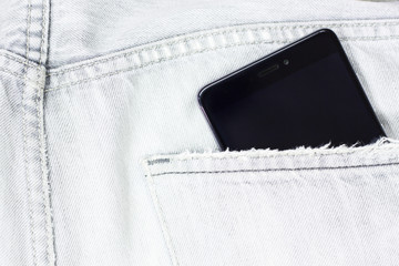 Closeup to jeans pocket with smartphone