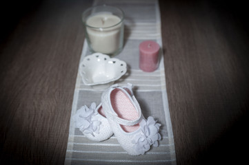 little white shoes and decorative candles on background, from above 