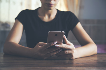 Young woman's hands holding smart phone