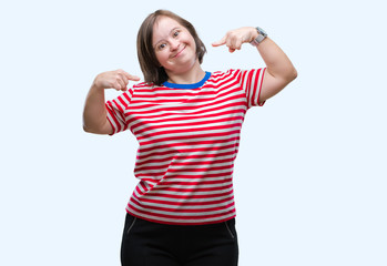 Young adult woman with down syndrome over isolated background smiling confident showing and...