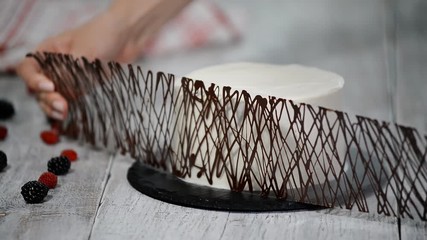 Decoration the cake with chocolate. Chocolate cake with cream.