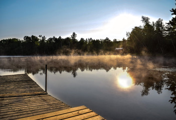 Fototapeta na wymiar foggy sunrise form the lake