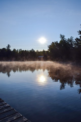 sunrise on a foggy lake