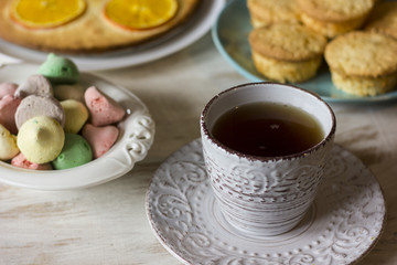 Tea with orange tarts and muffins