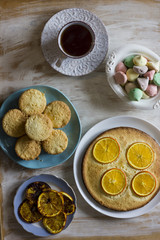Tea with orange tarts and muffins
