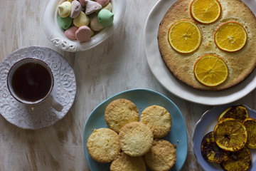 Tea with orange tarts and muffins
