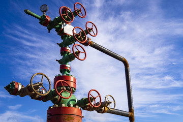 Horizontal view of a wellhead with valve armature. Oil and gas industry concept. Industrial site...