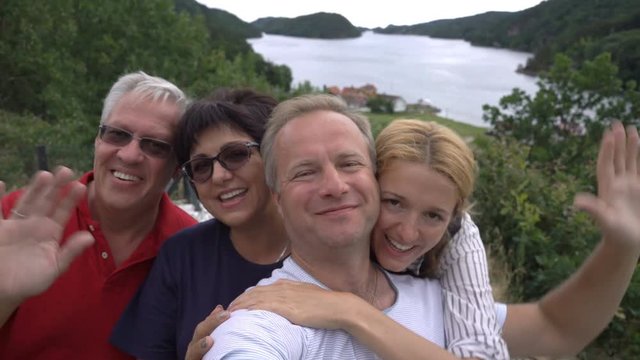 A great family adventure. A big happy family takes a selfie or Uses Phone Video Call Camera on the seacoast. Slow motion