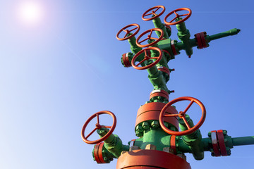 Horizontal view of a wellhead with valve armature. Oil and gas industry concept. Industrial site...