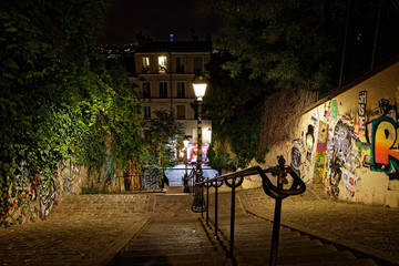 Paris, France - August 22, 2018: Stairs, lights and historical buildings on Montmartre by night