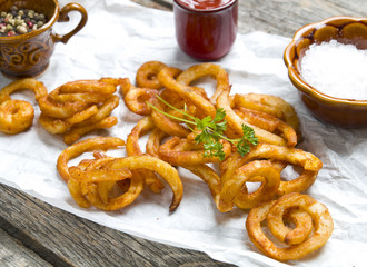 Curly fries on wood