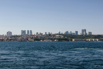 Fototapeta na wymiar View of Bosphorus and European side in Istanbul. It is a sunny summer day. Skyscrapers are also in the view.
