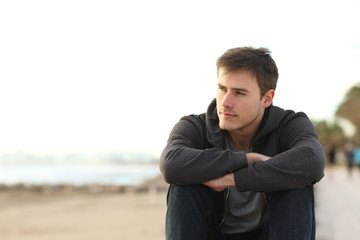 Confident pensive teen looking away on the beach